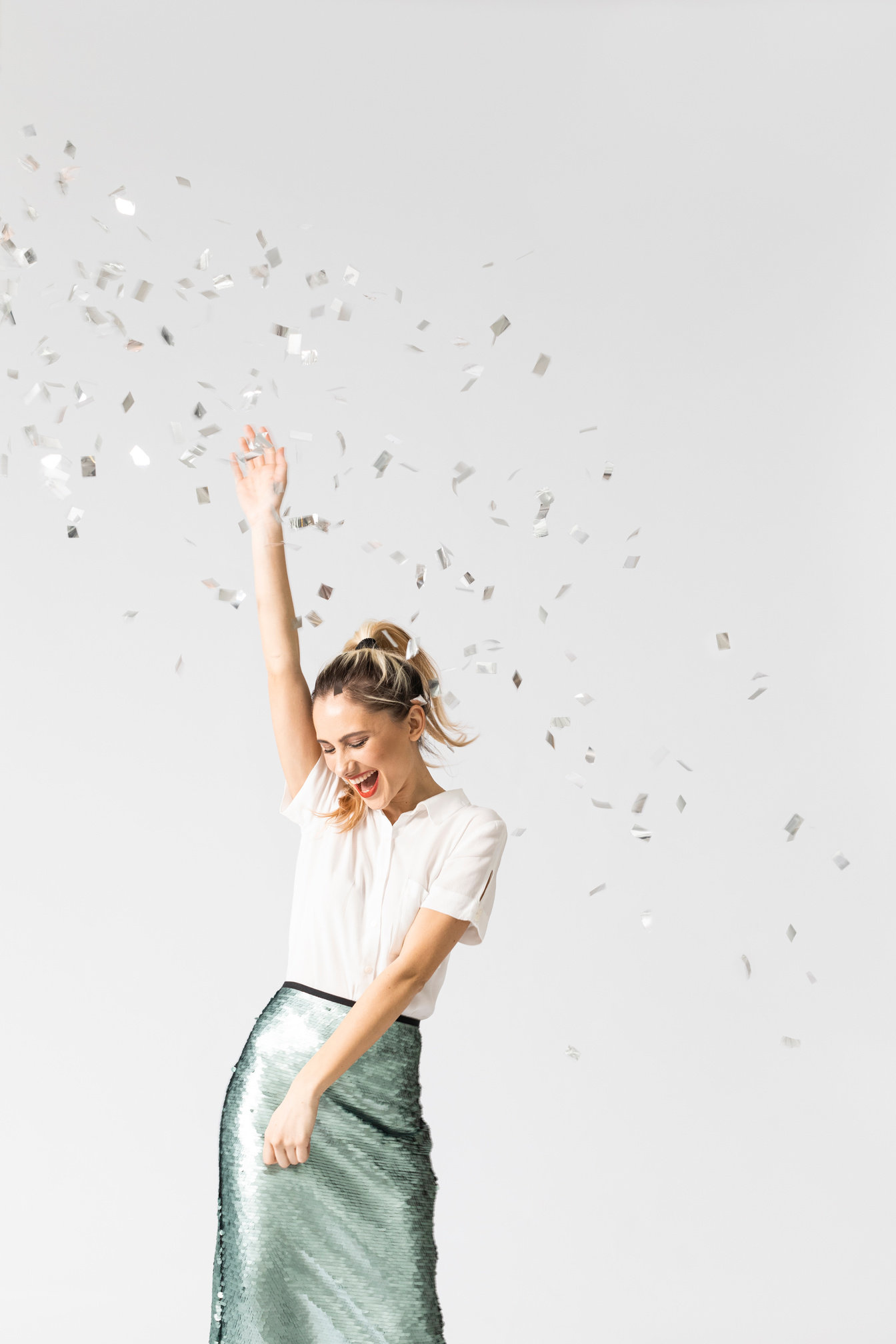 Happy Woman Dancing Under Confetti